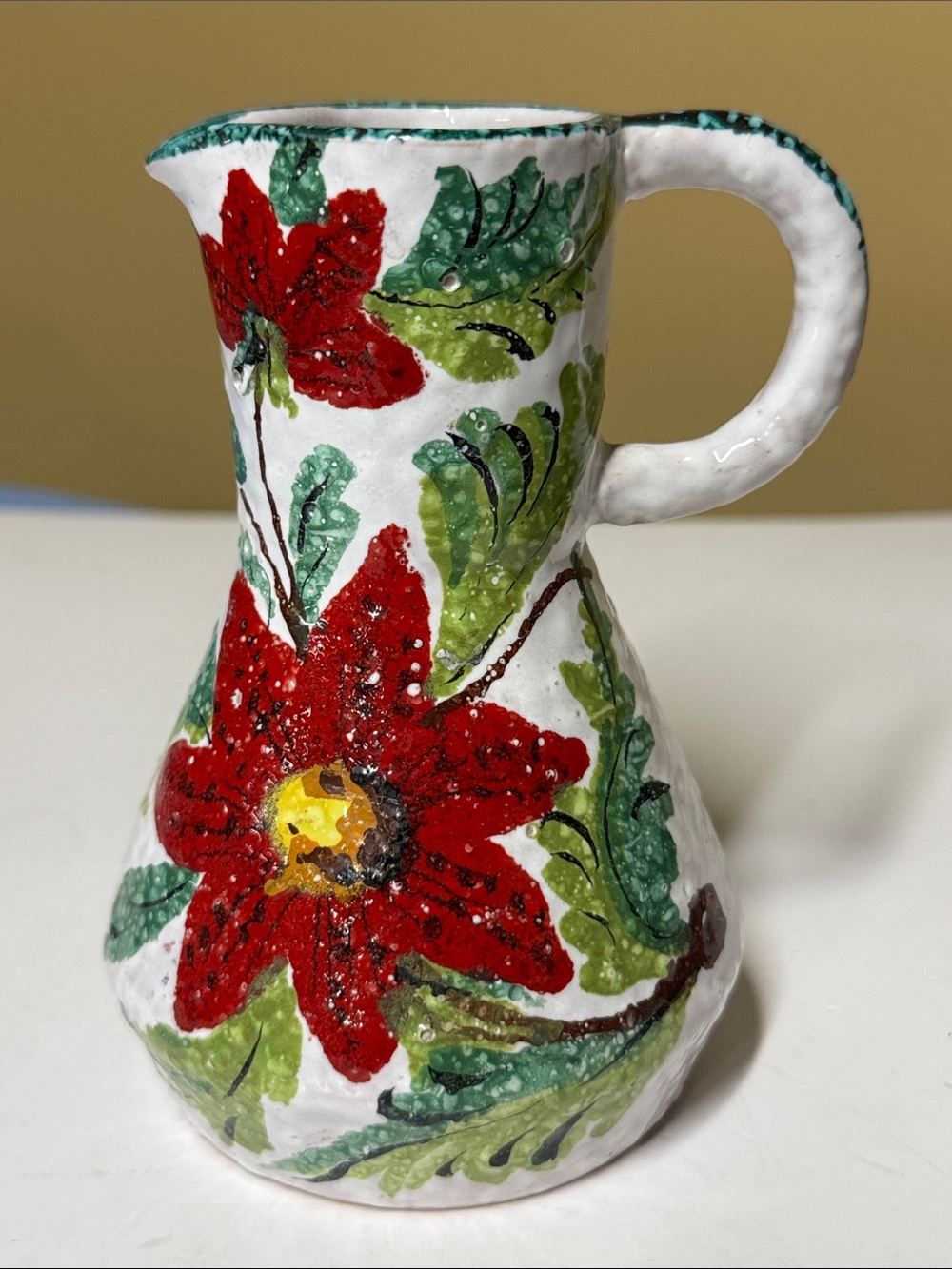 Italian faience majolica pottery pitcher hand-painted red poinsettia 5 5/8”